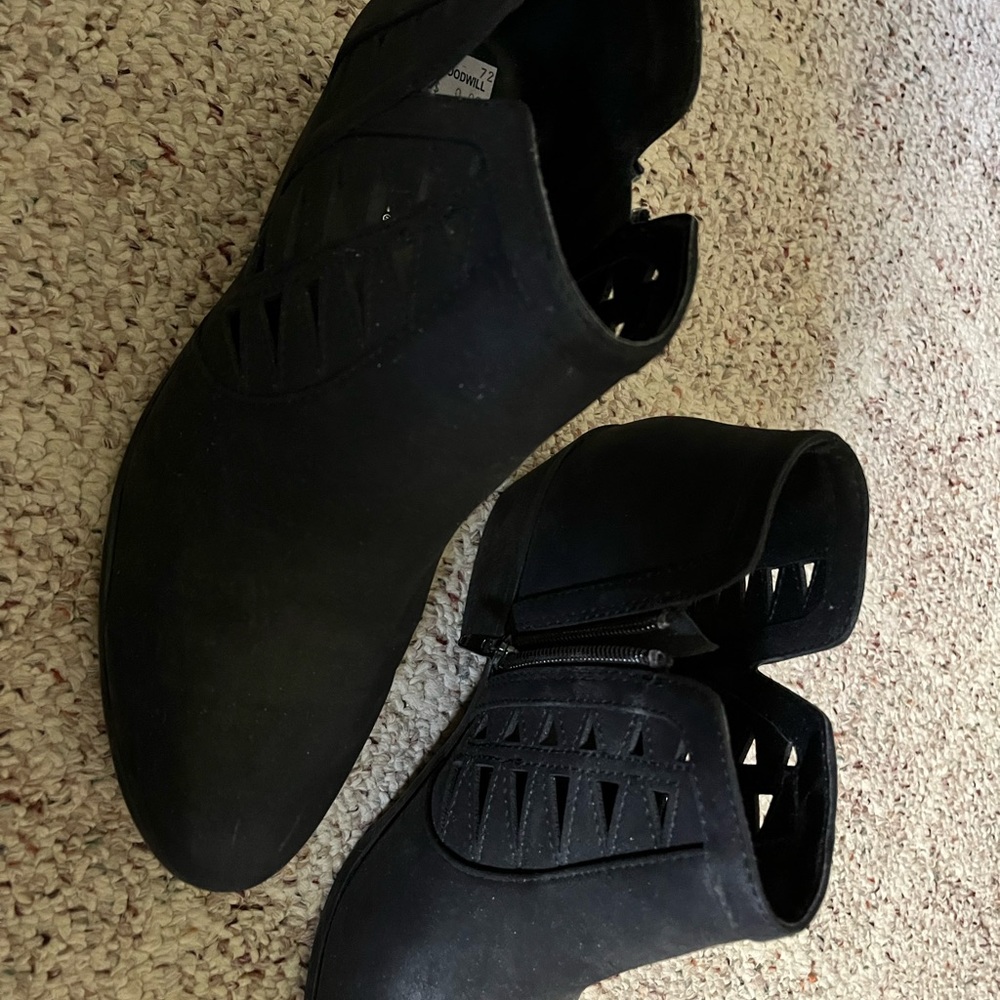 Black boots with decorative cutouts.